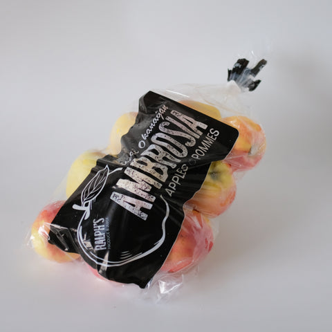 Packaged apples with 'Ambrosia' branding on a white background