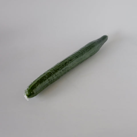 Green cucumber on a light gray background