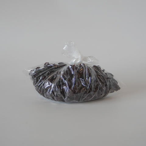 Bag of dried cherries on a light gray background