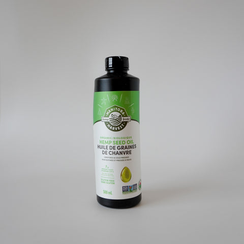 Bottle of hemp seed oil with a green label on a gray background