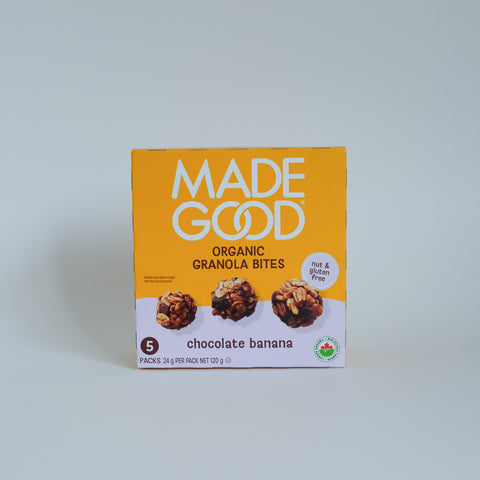 A box of Made Good Organic Granola Bites in chocolate banana flavor, featuring a bright yellow-orange front with white text and photos of the granola bites, set against a plain light gray background.