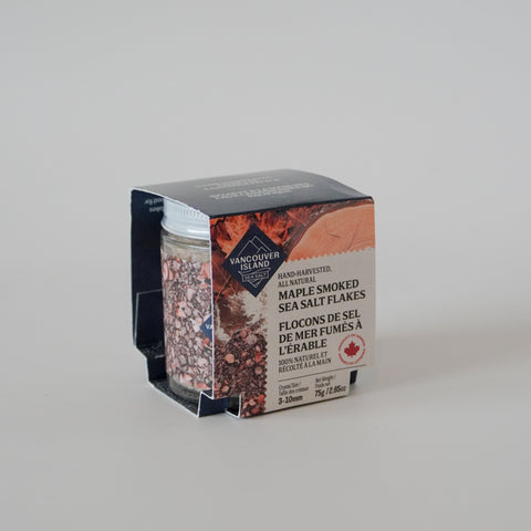 Jar of Vancouver Island maple smoked sea salt flakes with packaging on a light gray background