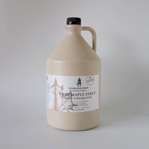 Gallon jug of pure maple syrup with a label on a gray background