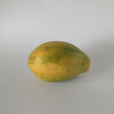 Yellow papaya on a gray background
