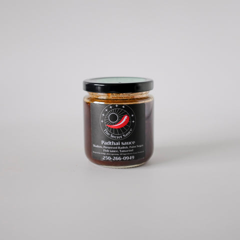 Jar of Padthai sauce with a black label on a white background