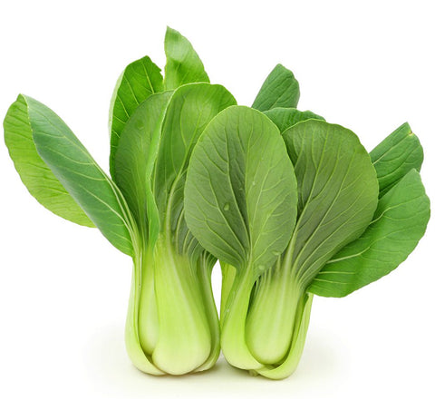 Bunch of green leafy vegetables on a white background